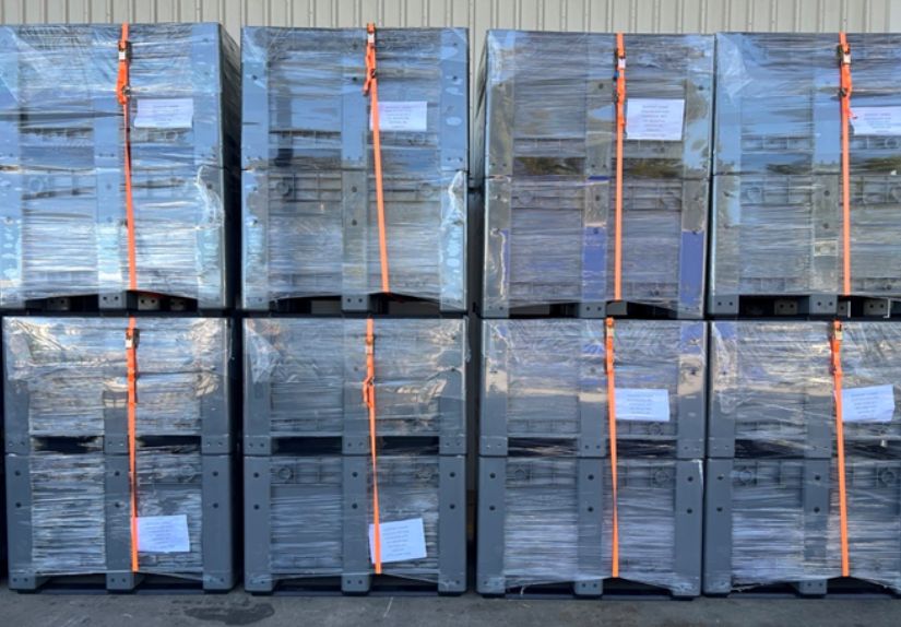 Heavy-duty storage crate strapped and ready for use on a mining site